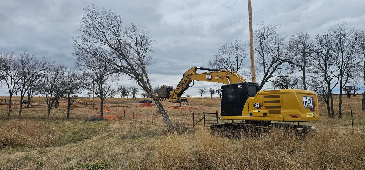 Skidder clearing brush and small trees on a wooded lot in the Oklahoma City, OK metro